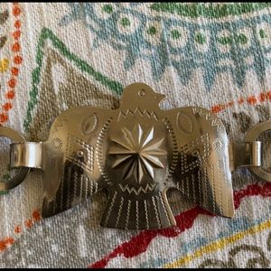 Thunderbird silver tone concho belt.